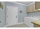 Convenient laundry room with a washer, dryer, and ample cabinet space at 2840 Mcleod Ln., Myrtle Beach, SC 29588