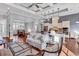 Open-concept living room and kitchen featuring hardwood floors, coffered ceilings, and modern lighting fixtures at 2840 Mcleod Ln., Myrtle Beach, SC 29588