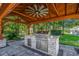 Outdoor kitchen featuring a stainless steel grill, granite countertops, and custom cabinetry under a pergola at 2840 Mcleod Ln., Myrtle Beach, SC 29588