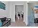 Bright and airy hallway with hardwood floors, white walls, and stylish decor leading into the living spaces at 3032 Red Bark Dr., Conway, SC 29526