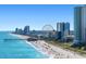 Aerial view of the beach showcasing shoreline, pier, ferris wheel and buildings at 311 69Th Ave. N # 505, Myrtle Beach, SC 29572