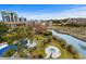 Aerial view of outdoor hot tub, lush landscaping, waterway, and other buildings at 311 69Th Ave. N # 505, Myrtle Beach, SC 29572