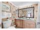 Bathroom featuring a double sink vanity, ample lighting, and tasteful floral wallpaper at 311 69Th Ave. N # 505, Myrtle Beach, SC 29572