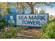 Community sign for Sea Mark Tower surrounded by colorful shrubbery at 311 69Th Ave. N # 505, Myrtle Beach, SC 29572