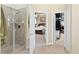 Neutral-toned bathroom features a walk-in shower, and the bedroom and closet are in the background at 320 Esher Ct., Myrtle Beach, SC 29579