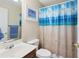 Bright bathroom with a beach themed shower curtain, vanity and sink plus a linen closet at 320 Esher Ct., Myrtle Beach, SC 29579