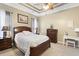 This beautiful bedroom has a tray ceiling, a fan, and wood furnishings at 320 Esher Ct., Myrtle Beach, SC 29579