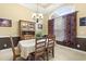 A formal dining area with a large window, elegant chandelier, and classic decor at 320 Esher Ct., Myrtle Beach, SC 29579