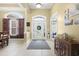 Bright entryway with decorative front door, transom windows, and neutral tile flooring at 320 Esher Ct., Myrtle Beach, SC 29579