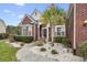 Beautifully landscaped brick home featuring a decorative palm tree and inviting entryway at 320 Esher Ct., Myrtle Beach, SC 29579