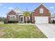 Charming brick home with a well-manicured lawn, palm tree, and attached two car garage at 320 Esher Ct., Myrtle Beach, SC 29579