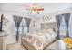 Cozy bedroom featuring a ceiling fan, neutral decor, and windows with decorative curtains at 3964 Lochview Dr., Myrtle Beach, SC 29588