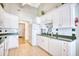 Bright kitchen featuring white cabinets, stainless steel appliances, and green countertops at 3964 Lochview Dr., Myrtle Beach, SC 29588