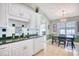 Charming kitchen featuring white cabinets, green countertops, and a dining area with chandelier at 3964 Lochview Dr., Myrtle Beach, SC 29588