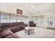 Sun-drenched living room featuring large windows, vaulted ceilings, and comfortable sectional sofa at 3964 Lochview Dr., Myrtle Beach, SC 29588