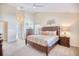 Main bedroom featuring vaulted ceilings, neutral walls, carpet, and a decorative tree wall hanging at 3964 Lochview Dr., Myrtle Beach, SC 29588