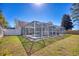 Backyard view of a screened-in pool and patio area surrounded by green grass at 3964 Lochview Dr., Myrtle Beach, SC 29588