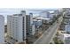 An aerial view of the building and neighboring areas, showcasing a road and the beach on the coastline at 4301 S Ocean Blvd. # 1-B, North Myrtle Beach, SC 29582