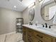 Bathroom with a modern double sink vanity, well-lit mirrors, and attractive tiling at 4301 S Ocean Blvd. # 1-B, North Myrtle Beach, SC 29582