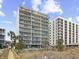 Scenic view of the condo's exterior with multiple balconies and vibrant green spaces that surround the property at 4301 S Ocean Blvd. # 1-B, North Myrtle Beach, SC 29582