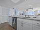 Well-lit kitchen with white cabinets, stainless steel dishwasher, and marble-look countertops at 4301 S Ocean Blvd. # 1-B, North Myrtle Beach, SC 29582