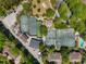 Aerial view of tennis courts, swimming pool, parking, and surrounding lush greenery and buildings at 435 Ocean Creek Dr. # 2705, Myrtle Beach, SC 29572