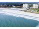 Aerial view of a white sand beach, blue ocean water, and modern high-rise condominiums at 435 Ocean Creek Dr. # 2705, Myrtle Beach, SC 29572