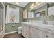 Well-lit bathroom showcasing a double vanity, tile backsplash, and window for natural light at 435 Ocean Creek Dr. # 2705, Myrtle Beach, SC 29572