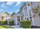 Two-story townhouse with gray siding, white trim, well-maintained landscaping and front porch at 435 Ocean Creek Dr. # 2705, Myrtle Beach, SC 29572