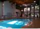 Bright indoor swimming pool area with large windows and ample seating at 435 Ocean Creek Dr. # 2705, Myrtle Beach, SC 29572
