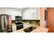 Efficient kitchen with stainless steel appliances, granite countertops, and white cabinets at 435 Ocean Creek Dr. # 2705, Myrtle Beach, SC 29572