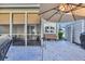 Spacious outdoor patio with seating, screened-in porch, and umbrella shade at 435 Ocean Creek Dr. # 2705, Myrtle Beach, SC 29572