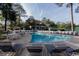 Exterior view of a sparkling community pool with lounge chairs and surrounding greenery at 435 Ocean Creek Dr. # 2705, Myrtle Beach, SC 29572