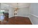 Elegant dining room featuring hardwood floors and a chandelier, open to the kitchen area at 517 Poppi Point Ct. # 517, Myrtle Beach, SC 29579