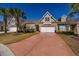 Charming brick townhome with a two-car garage, well-manicured lawn, and a vibrant, reddish-brown driveway at 517 Poppi Point Ct. # 517, Myrtle Beach, SC 29579