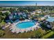 Aerial view of a community pool with tables, chairs, and palm trees at 517 Poppi Point Ct. # 517, Myrtle Beach, SC 29579