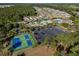 Aerial view of a community pool, parking lot and tennis court at 517 Poppi Point Ct. # 517, Myrtle Beach, SC 29579