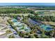 Aerial view of community pool and tennis courts with surrounding trees at 517 Poppi Point Ct. # 517, Myrtle Beach, SC 29579