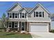 Charming two-story home with gray siding, stone accents, and a well-manicured front yard at 534 Haven View Way, Murrells Inlet, SC 29576