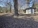 Spacious backyard featuring a storage shed surrounded by trees, offering a private outdoor space at 57 Tallahassee Rd., Georgetown, SC 29440