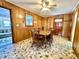 Dining room featuring wood paneling, a wooden table, and vintage decor at 57 Tallahassee Rd., Georgetown, SC 29440