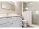 Modern bathroom with a white vanity, quartz countertops, and a glass-enclosed shower with light tile at 601 N Hillside Dr. # 2331, North Myrtle Beach, SC 29582