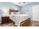 Comfortable bedroom featuring a wooden bedframe, a ceiling fan, and soft blue walls at 601 N Hillside Dr. # 2331, North Myrtle Beach, SC 29582