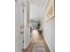 Bright hallway with wood floors, white wainscoting, and an open view into the living area at 601 N Hillside Dr. # 2331, North Myrtle Beach, SC 29582