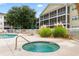 Community hot tub area surrounded by lounge chairs and yellow condominium buildings at 601 N Hillside Dr. # 2331, North Myrtle Beach, SC 29582