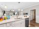 Well-lit kitchen with white cabinets, stainless steel dishwasher, and view of the open living area at 601 N Hillside Dr. # 2331, North Myrtle Beach, SC 29582