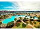 Stunning aerial view of community pool with marina and distant city skyline at 6095 Catalina Dr. # 1614, North Myrtle Beach, SC 29582