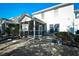 A view of the home's backyard featuring a screened-in porch and outdoor seating at 6095 Catalina Dr. # 1614, North Myrtle Beach, SC 29582
