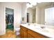 Bathroom features a dual sink vanity, a toilet, and a walk-in closet at 6095 Catalina Dr. # 1614, North Myrtle Beach, SC 29582