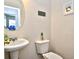 A half bathroom featuring a pedestal sink, toilet, mirror, and a framed picture at 6095 Catalina Dr. # 1614, North Myrtle Beach, SC 29582